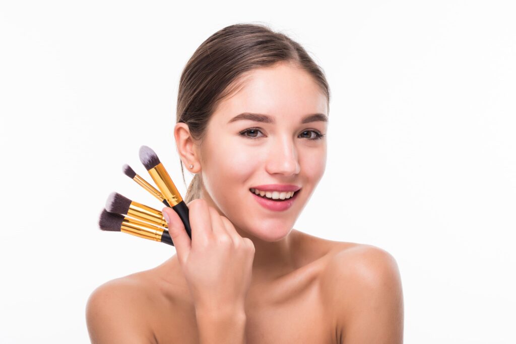 Woman Holding Makeup Brushes